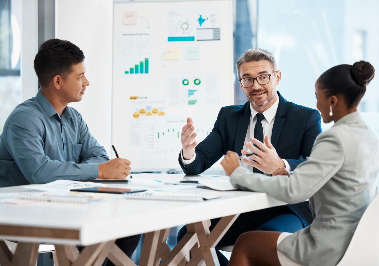 Business professionals engaged in a meeting within an office setting, discussing small business loans in Ontario